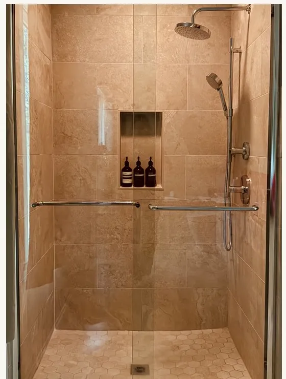 A tiled walk-in shower with a rainfall head